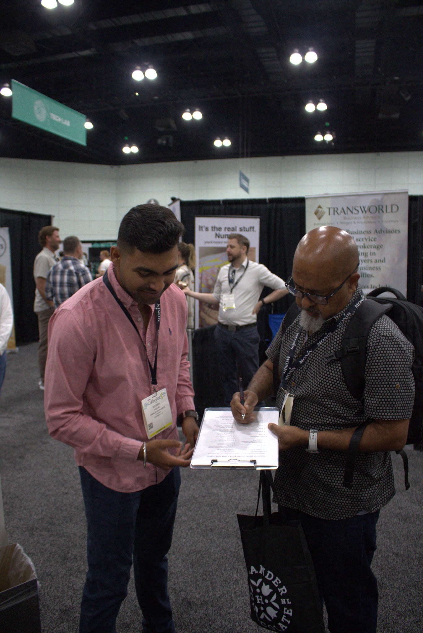 Coffee roasters and cafe owners signing partnership forms with Himalayan Blends at coffee festival